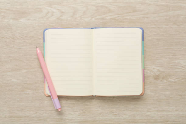 istock Open notebook with stationery on wooden background, top view 1610297462