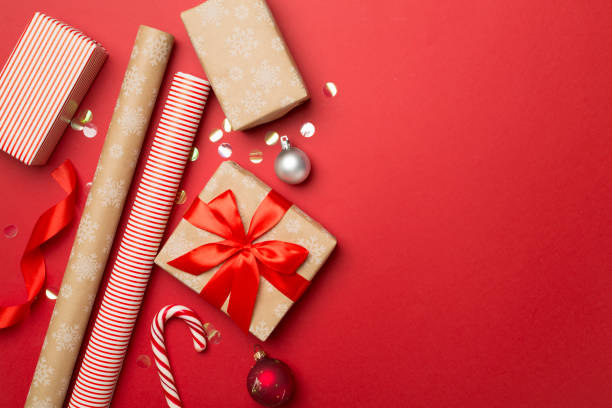 istock Gift boxes, paper's rools and decorations on color background, top view 1610324784