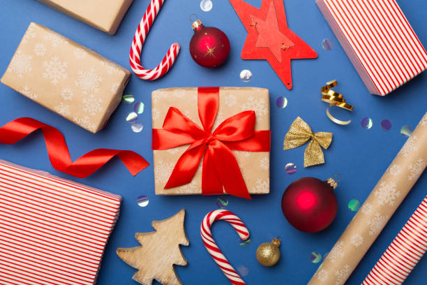 istock Gift boxes, paper's rools and decorations on color background, top view 1610325300