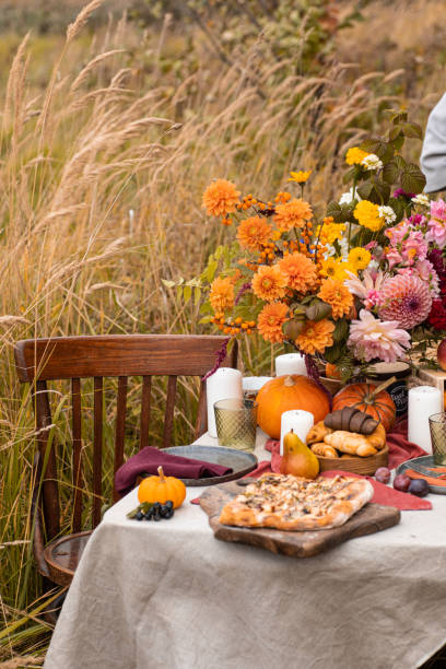 istock Thanksgiving dinner preparation. Table with pumpkin, autumn season pie. Decorated kitchen in Halloween season. Cooking celebration feast. Fall seasonal table. 1610330173