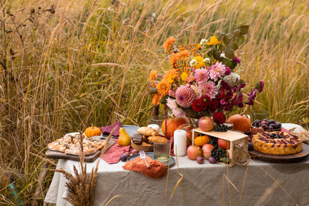istock Thanksgiving dinner preparation. Table with pumpkin, autumn season pie. Decorated kitchen in Halloween season. Cooking celebration feast. Fall seasonal table. 1610330693