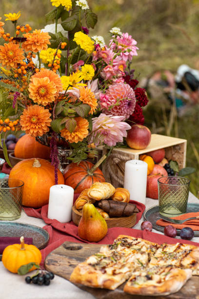 istock Thanksgiving dinner preparation. Table with pumpkin, autumn season pie. Decorated kitchen in Halloween season. Cooking celebration feast. Fall seasonal table. 1610331094