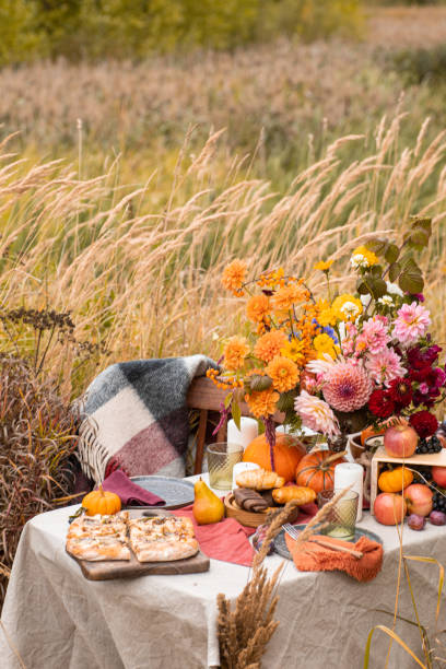 istock Thanksgiving dinner preparation. Table with pumpkin, autumn season pie. Decorated kitchen in Halloween season. Cooking celebration feast. Fall seasonal table. 1610331754