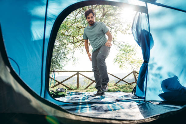 istock man entering in the tent at the camping 1610334521