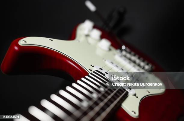 Closeup Of A Red Electric Guitar On A Black Background Selective Narrow Focus On Pickup Stock Photo - Download Image Now
