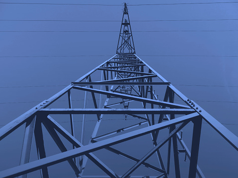 An abstract, subjective and low-angle view,  of an High-voltage Transmission Pylon, shot in early April 2023, in Dusseldorf, Germany.