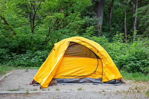 Yellow two person tent in a campground