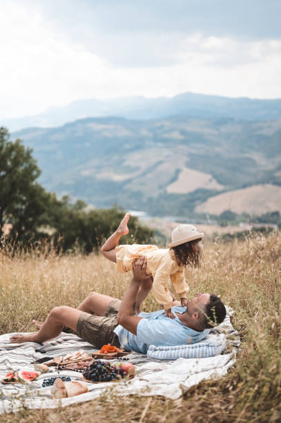 istock father having fun with daughter in a natural park. 1610405555