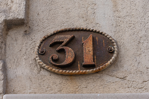 House number 31 in old french style rusty metal
