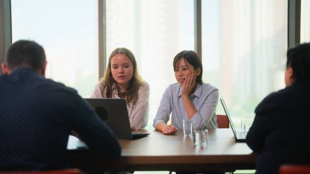 istock Two multi-racial businesswomen presenting their ideas to each other collaborating and working together in boardroom 1610425459