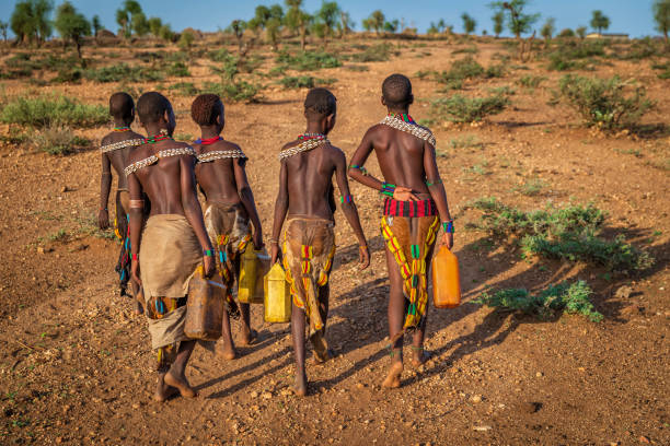 African girls carrying water from the well, Ethiopia, Africa
