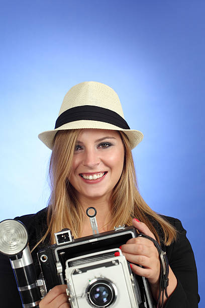 istock Blond woman pointing an old camera 161042946