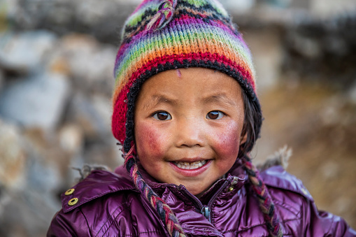 Portrait of little boy, Sherpa village in Mount Everest National Park. This is the highest national park in the world, with the entire park located above 3,000 m ( 9,700 ft). This park includes three peaks higher than 8,000 m, including Mt Everest. Therefore, most of the park area is very rugged and steep, with its terrain cut by deep rivers and glaciers.