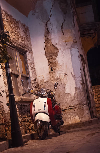 istock White vintage scooter parked at night 161045390
