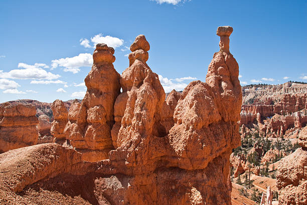 Three Hoodoos in a Row Bryce Canyon is famous for its tall thin spires of rock known as hoodoos. Hoodoos start with an initial deposition of rock. Then over time the rock is uplifted then eroded and weathered. Hoodoos typically consist of relatively soft rock topped by harder, less easily eroded stone that protects each column from the weather. Hoodoos generally form within sedimentary rock such as sandstone. These hoodoos were photographed from the Queen's Garden Trail in Bryce Canyon National Park, Utah, USA. jeff goulden bryce canyon national park stock pictures, royalty-free photos & images