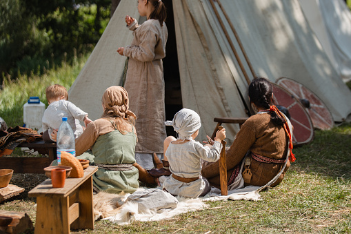 women and children in the knight camp - Festival of Medieval Life with Authentic Clothing - Historical Reenactment Club for people who are passionate about history