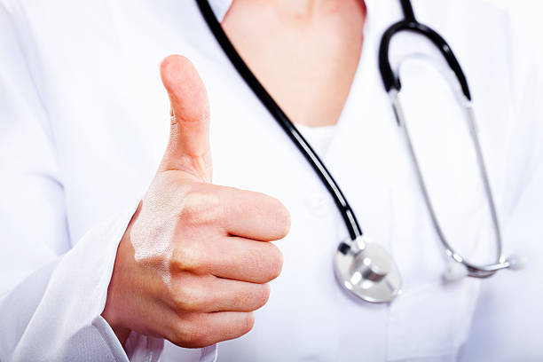 istock female doctor with thumbs up gesture. 161049670