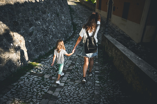 family walking in an ancient town in Italy.