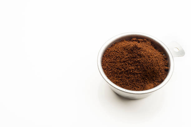 Ground coffee in a 1/2 cup measure to prepare a delicious express coffee .