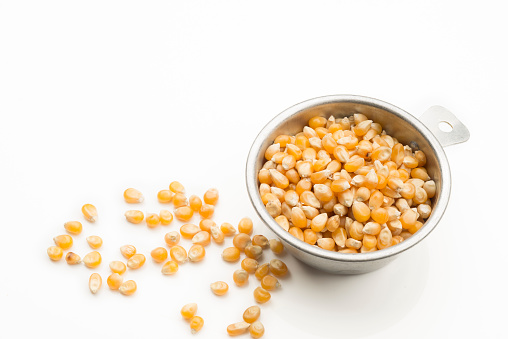 Corn grains for popcorn in a 1/2 cup measure to prepare an exact amount