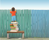 istock Schoolboy on pile of books looking over fence 161057193