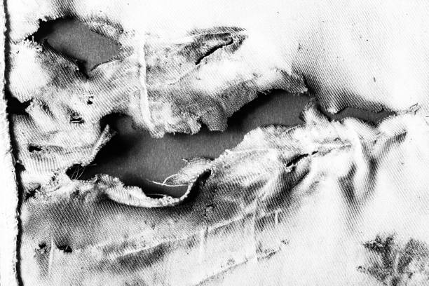 Black and white damaged cloth close-up photo. stock photo