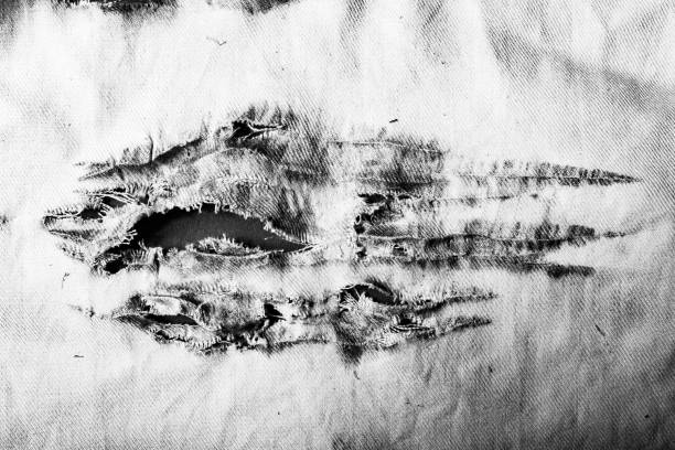 Black and white damaged cloth close-up photo. stock photo