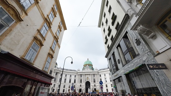 Vienna, Austria - June 8, 2023: Buildings on the street and Hofburg palace in Vienna city, Austria.