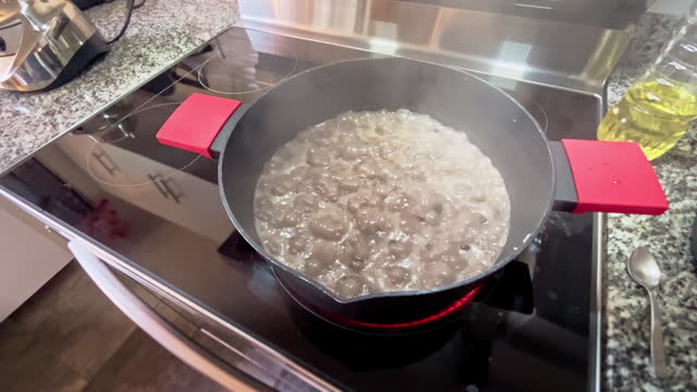 Cooking black beans boiling on a electric stove