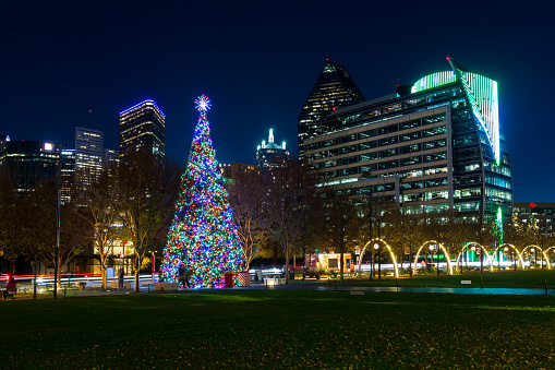 Dallas, Texas, USA - December 23rd, 2021: Christmas tree in the Klyde Warren Park in downtown surrounded by high-rise buildings