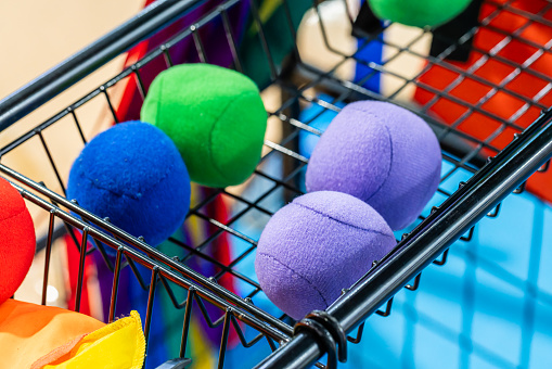 Close up of several different colored colorful plastic balls with small ball for bocce game on white background