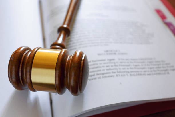 Gavel On A Legal Document A gavel rests on top of a legal document. legal document stock pictures, royalty-free photos & images