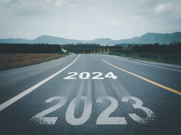 istock White arrow and text 2023 to 2024 on the road 1610963865