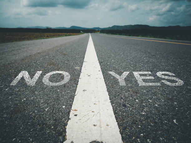 istock Yes or NO text on asphalt road 1610964911