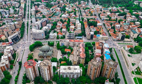 An expansive aerial shot of the bustling cityscape of Skopje in the Republic of Macedonia
