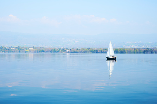 A landscape of Lake Geneva on a sunny day from a ferry traveling from Nyon, Switzerland to Yvoire, France