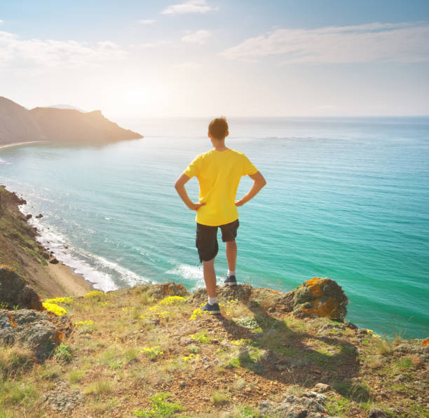 istock Man and sea mountain landscape. 1611194750