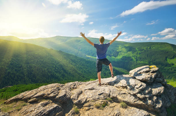 istock Man on peak of mountain. 1611196848