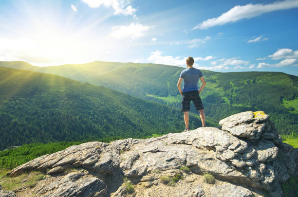 istock Man on peak of mountain. 1611197279
