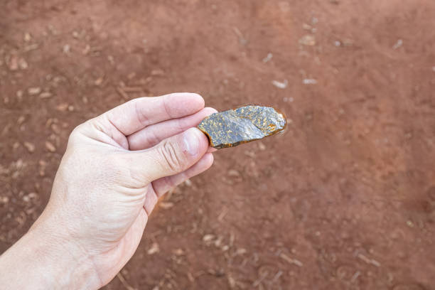 istock hand holding piece of gold ore 1611251386