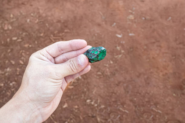 istock hand holding a small piece of emerald 1611261898