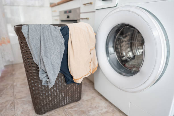 istock Clothes hanging from a basket ready to put them in the automatic washing machine. 1611301426