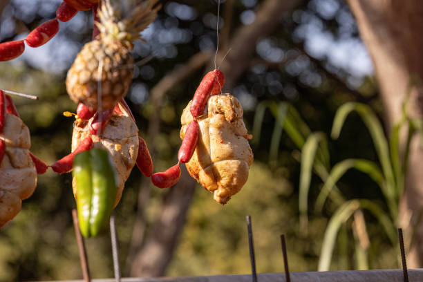 istock hanging chicken meat roasting outdoors 1611341833