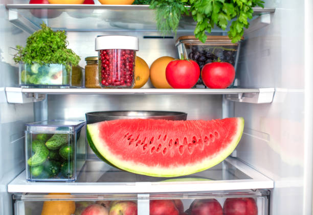 Open fridge full of fresh fruits and vegetables, vegetarian food healthy food background, greenery, organic nutrition, health care, dieting concept. stock photo