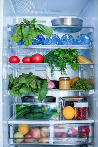 Open fridge full of fresh fruits and vegetables, vegetarian food healthy food background, greenery, organic nutrition, health care, dieting concept
