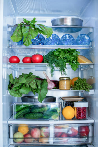 Open fridge full of fresh fruits and vegetables, vegetarian food healthy food background, greenery, organic nutrition, health care, dieting concept. stock photo