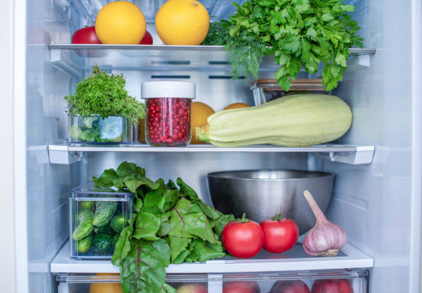 Open fridge full of fresh fruits and vegetables, vegetarian food healthy food background, greenery, organic nutrition, health care, dieting concept. stock photo