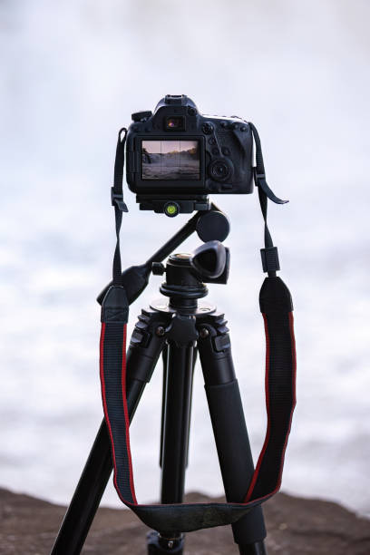 istock photo camera on tripod to photograph a waterfall 1611371617