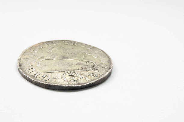 istock Silver old coin isolated on white background 1611373262