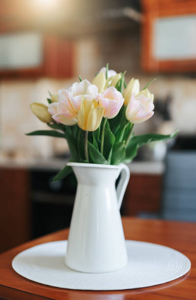 istock Spring tulips in a vase on the table. Spring holiday, home decor. 1611414734